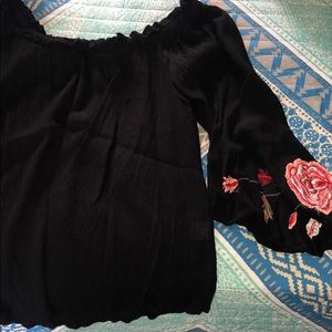 Black off the shoulder shirt with roses on sleeves